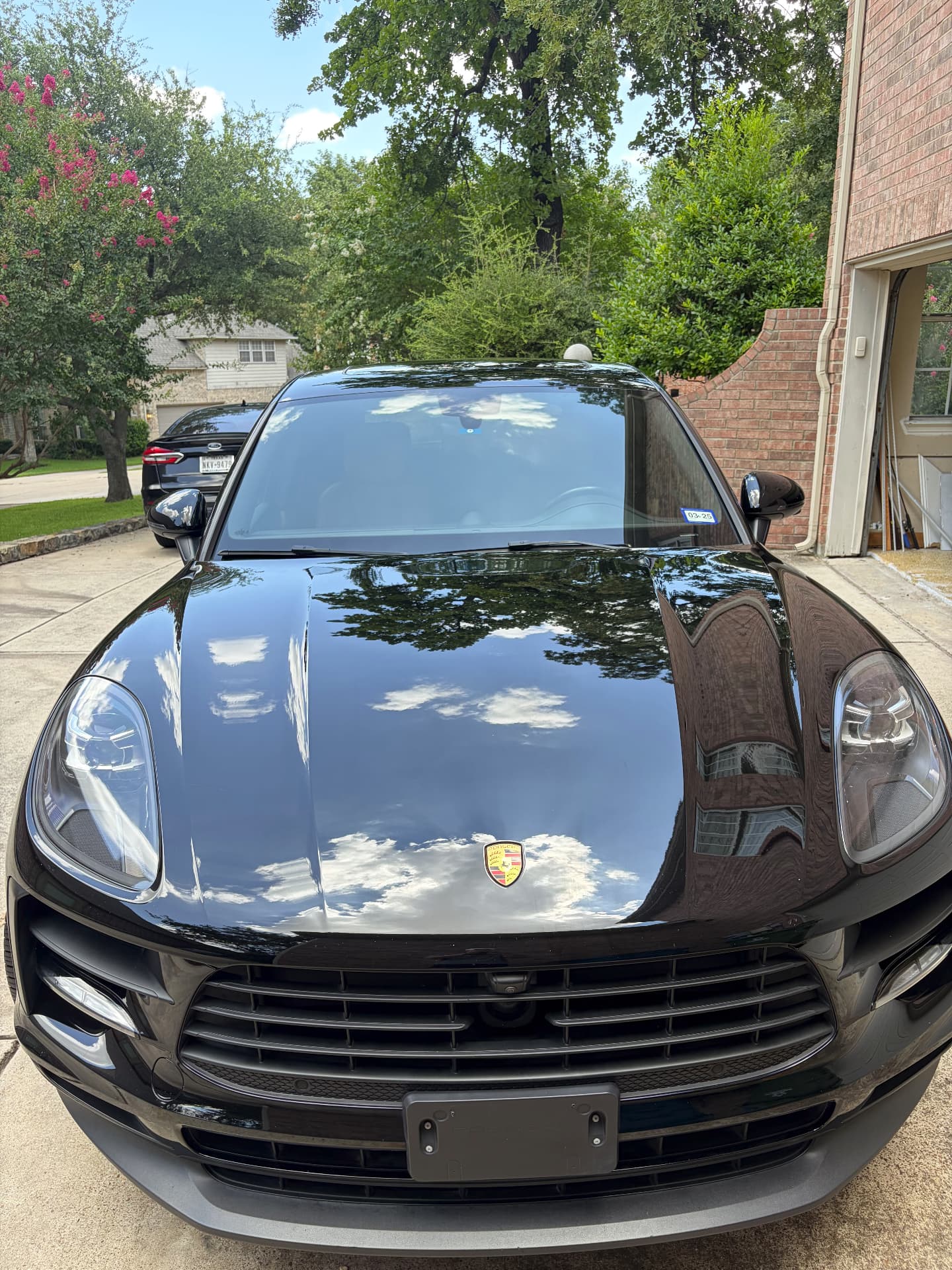 Glossy black Porsche Macan after a DoRight Detailing mobile detail in a DFW driveway